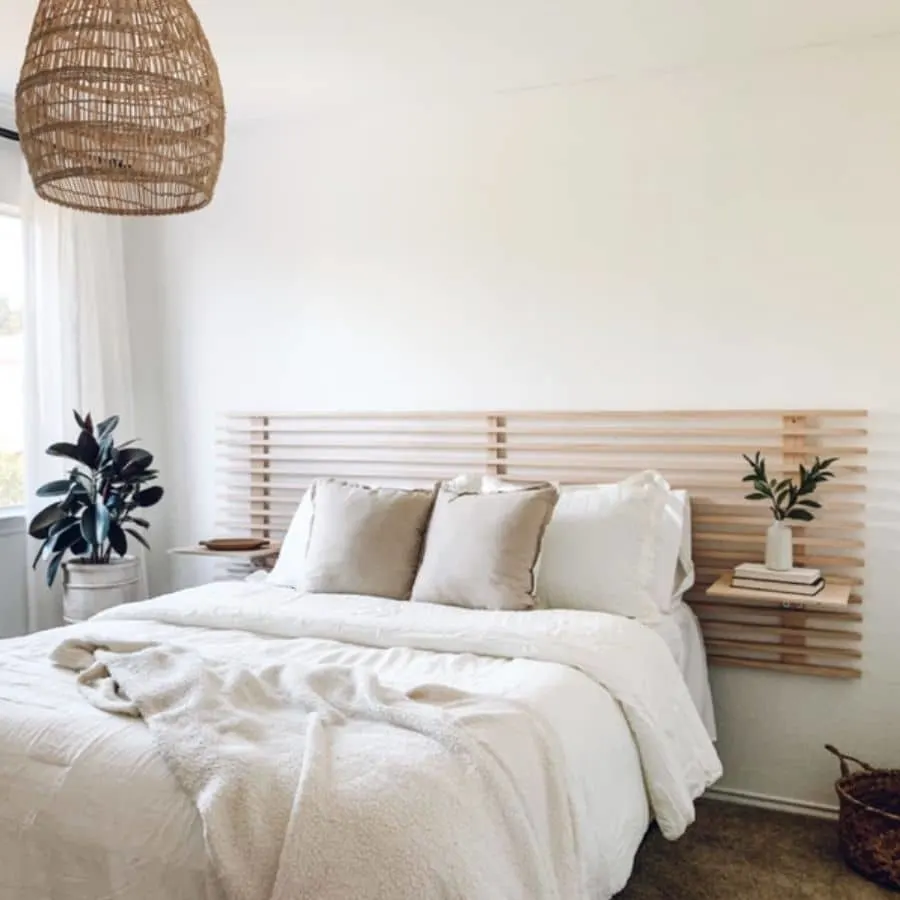 A DIY headboard made out of wooden slates that also creates little floating nightstands.