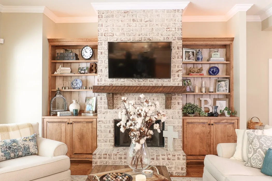 Accessorized bookcases on each side of a fireplace
