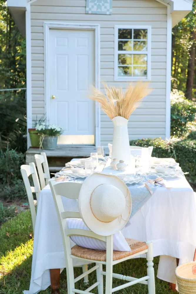 Hat on the back of a chair for guest to wear at outdoor dinner party