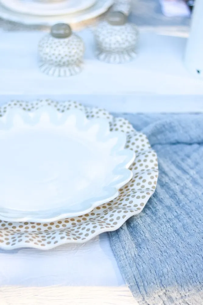 Dinner plate by Coton Colors sitting on a ruffled polka dot platter