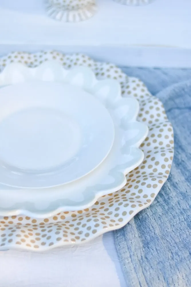 White salad plate sitting on a Coton Color dinner plate which is sitting on a ruffled polka dot platter for a fall tablescape.