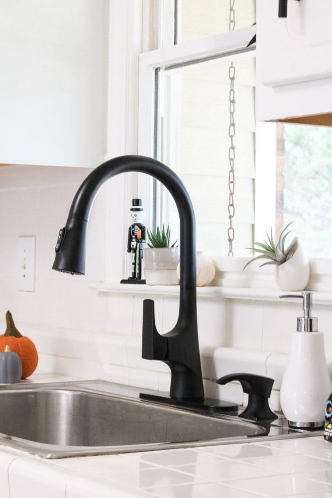 Tall neck on a matte black kitchen faucet for easy washing of dishes