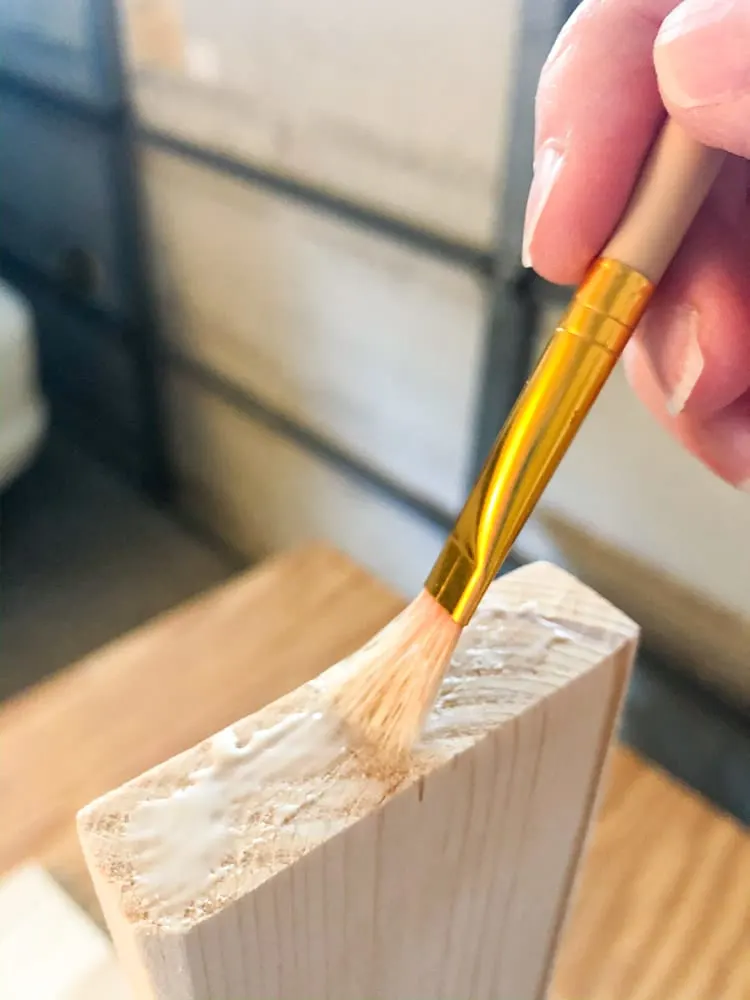 Applying glue to a piece of wood for a wood bench