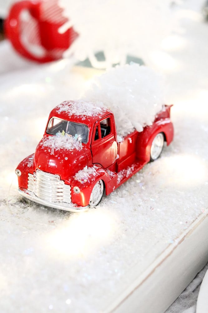 Red Christmas truck carrying a mini yarn tree