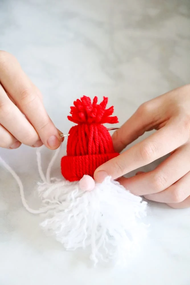 Sew through the top of the beanie to make a Christmas Santa garland