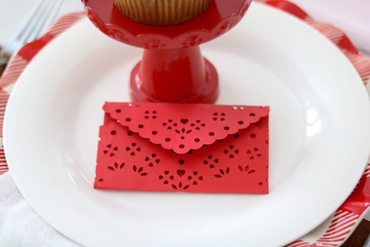 Heart doily envelope as a place setting on family friendly dinner table ideas