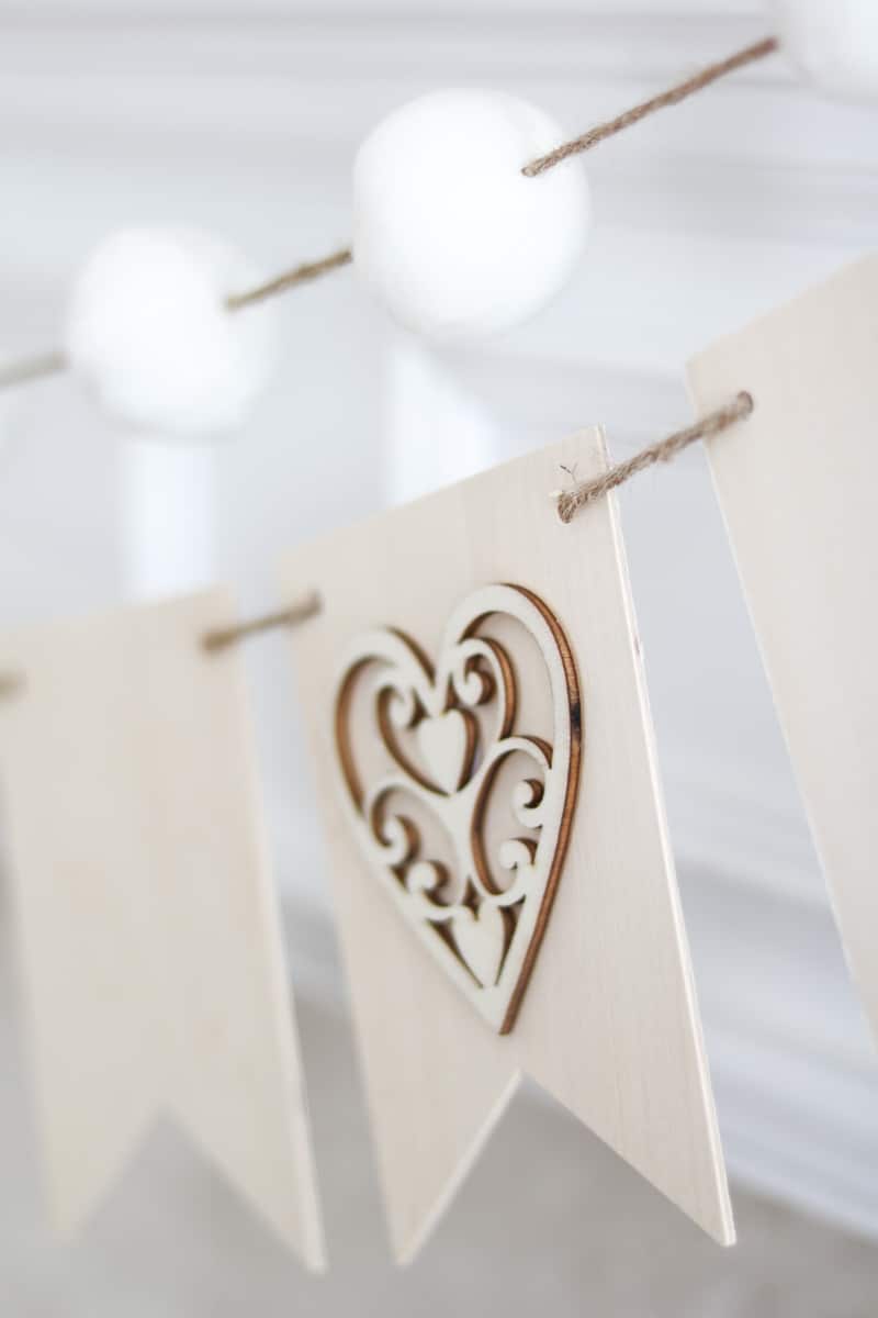 Neutral Valentine decor of a wood banner garland with hearts