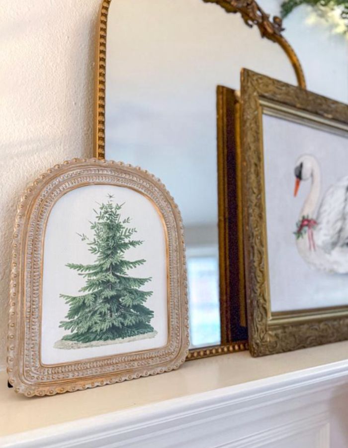 Christmas printable wall art vintage evergreen tree in arched frame on holiday mantel