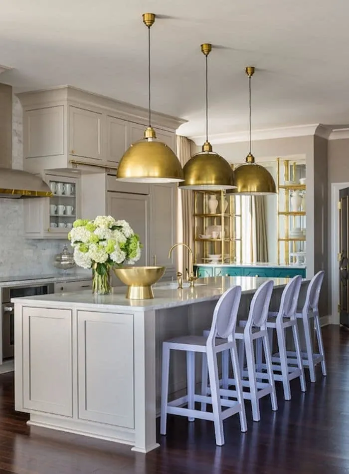 Popular Sherwin Williams cabinet colors, anew gray. A beautiful kitchen with gold dome hanging lights with matching gold accessories in this kitchen.