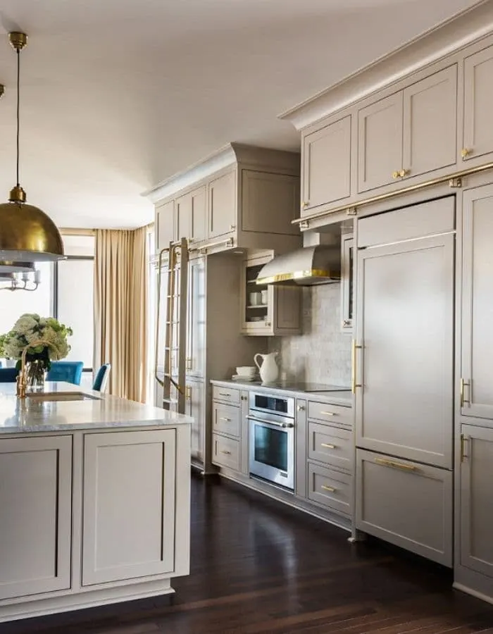 Popular Sherwin Williams cabinet colors, anew gray. A beautiful kitchen with gold dome hanging lights with matching gold accessories in this kitchen.
