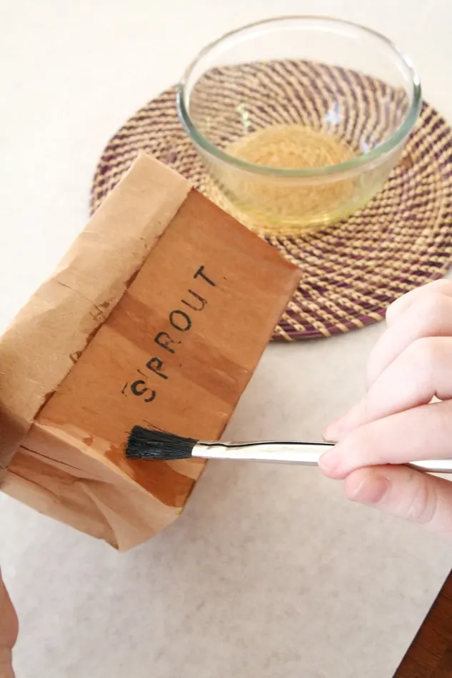 Apply wax to brown paper bag planter to make it water resistant