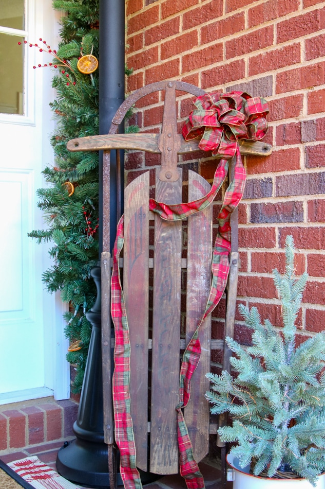 Decorating with ribbon on a sled at Christmas