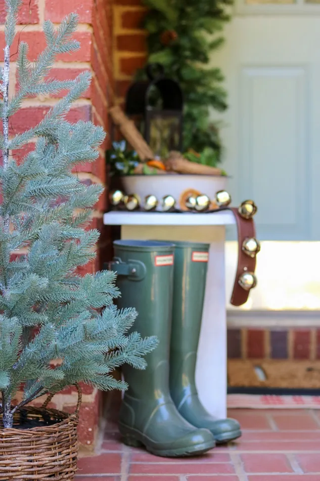 Father Christmas themed front porch with rainboots by the door
