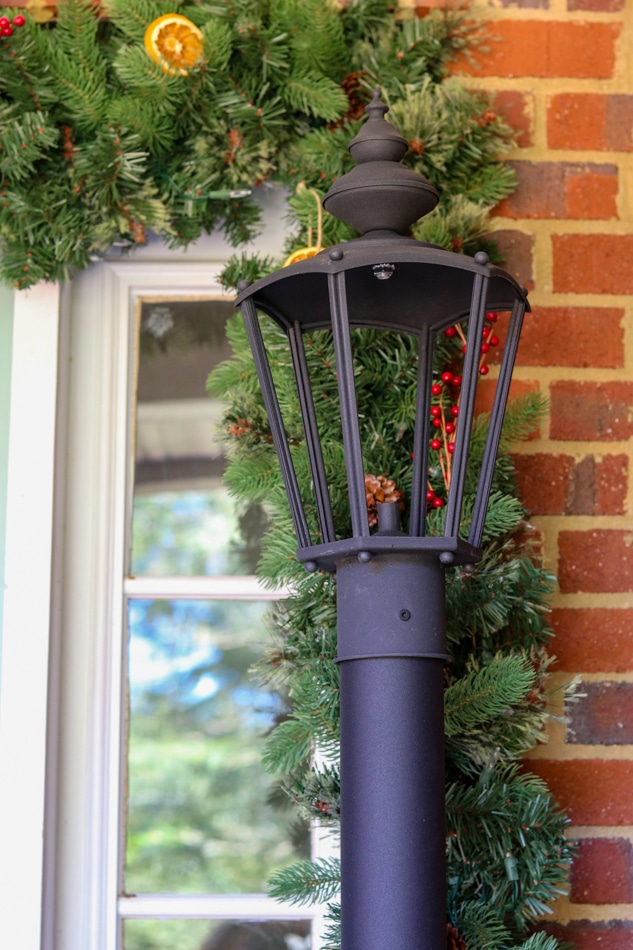 Citronella vintage lamppost on a Christmas front porch