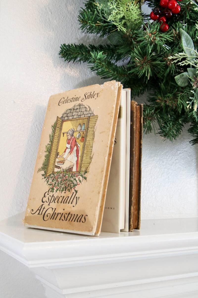 Vintage old books on a farmhouse Christmas mantel