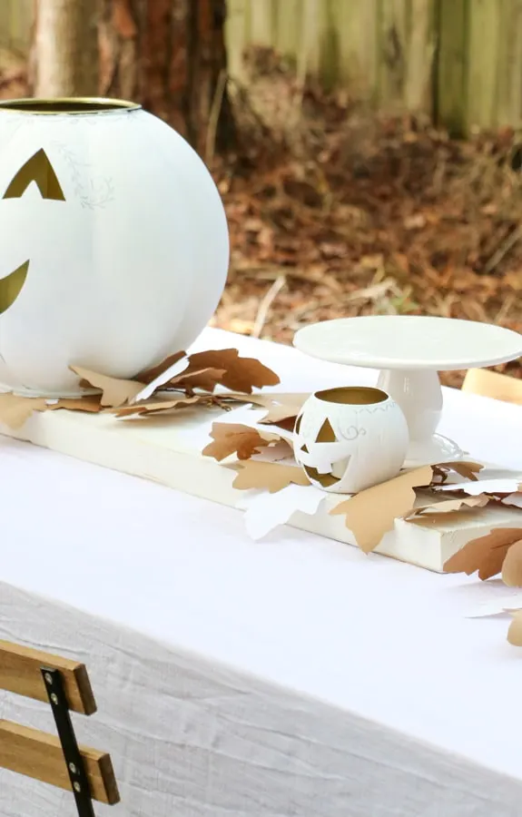 White jack o lantern centerpiece for a Halloween dinner party table