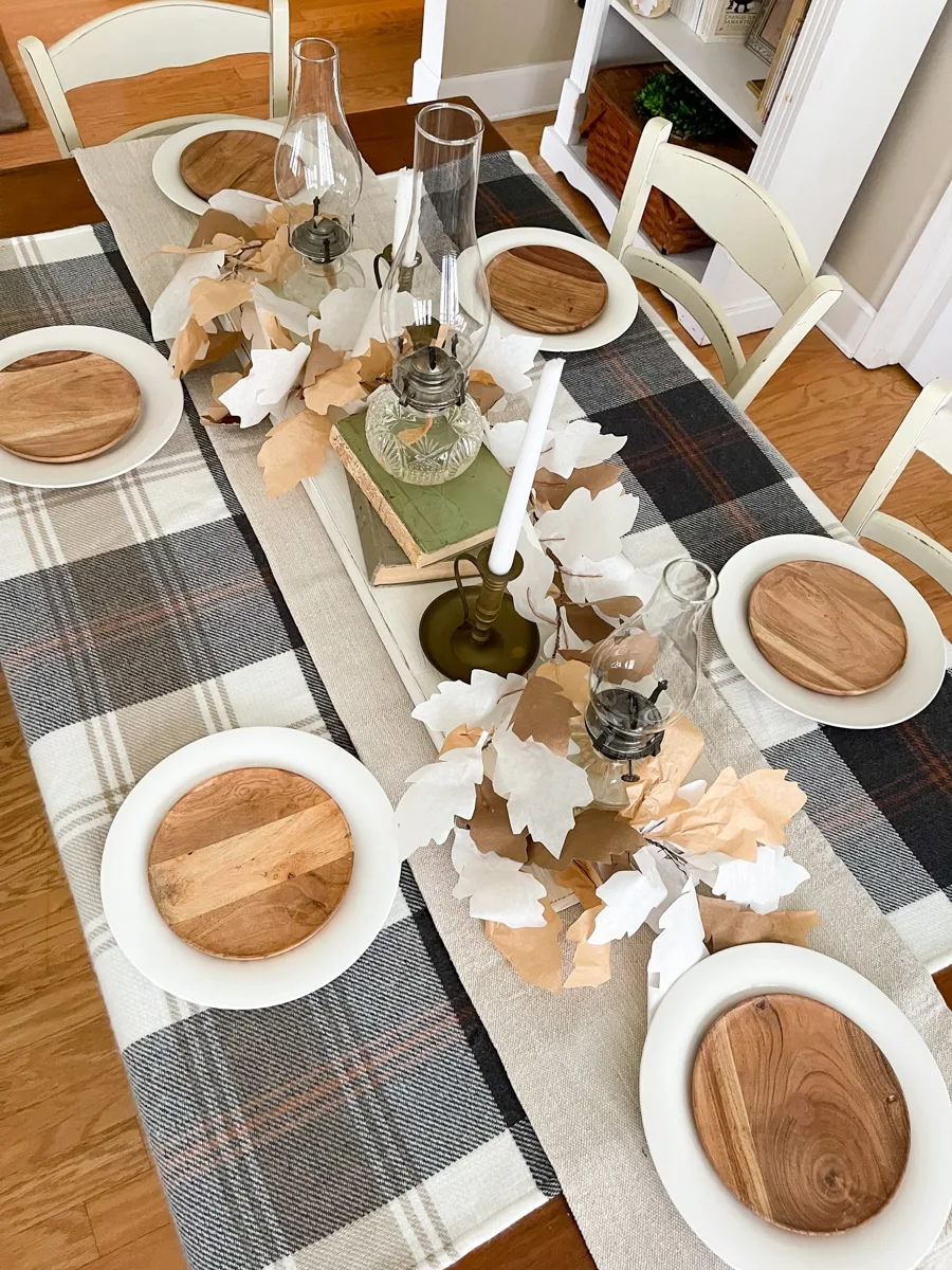 Wooden plate on white plate for Thanksgiving table