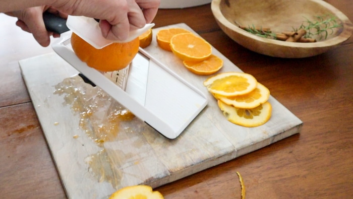 Cutting an orange in a mandolin