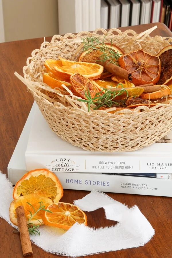 Basket of dried oranges with rosemary and cinnamon sticks