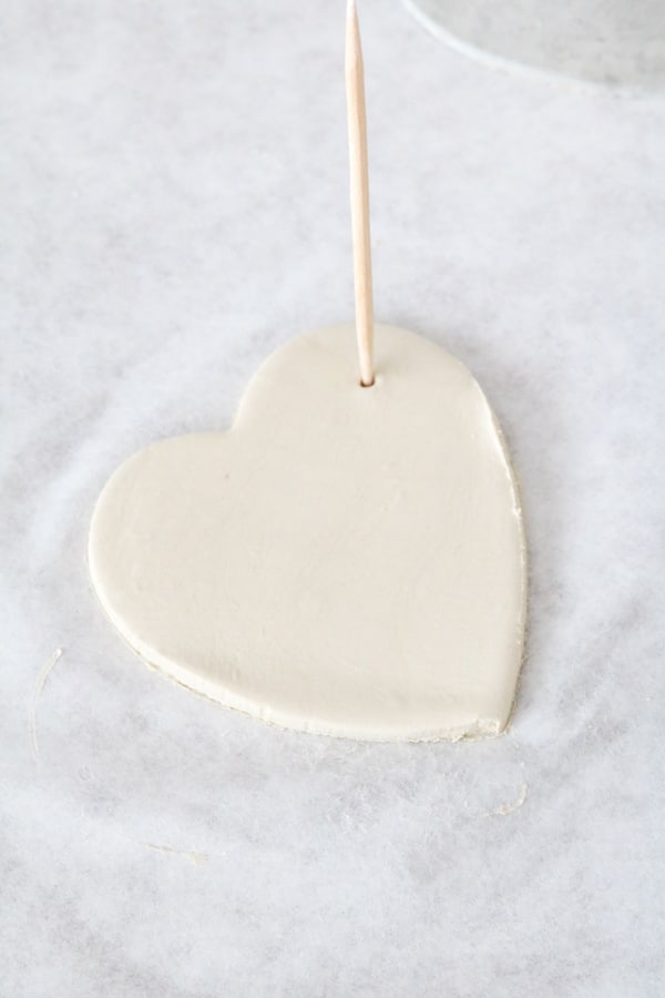 Adding holes to air dry clay hearts for a Valentine garland