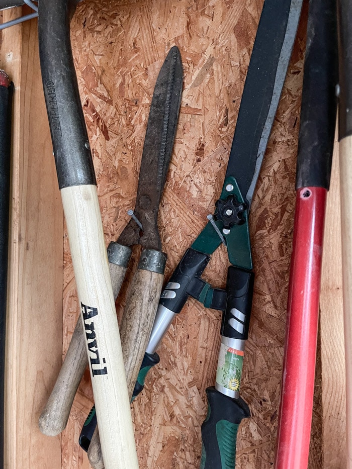 Hanging tools onto nails in a garden shed
