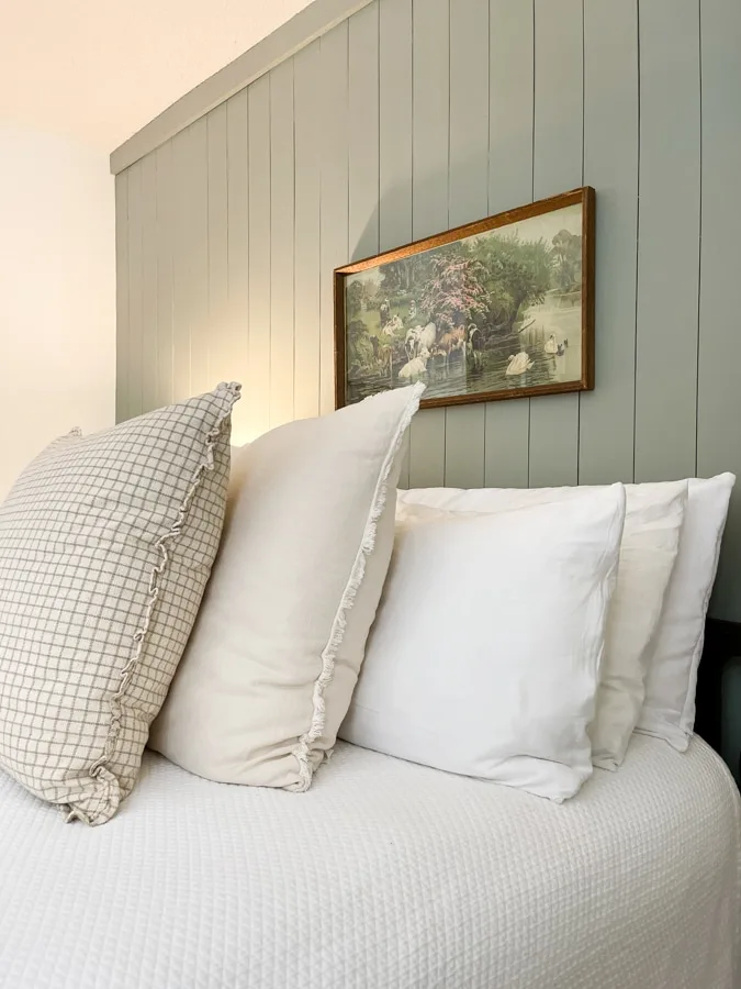 Natural fabrics of linen and cotton for bedding in a vintage style bedroom