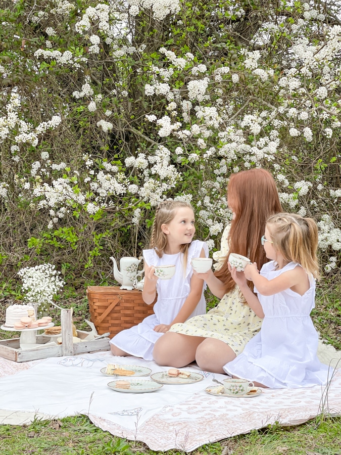 Kids dressing in white eyelet dressed for a tea party