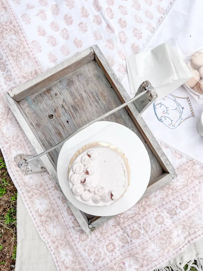 Decorating for a tea party picnic with cake stand on a tray