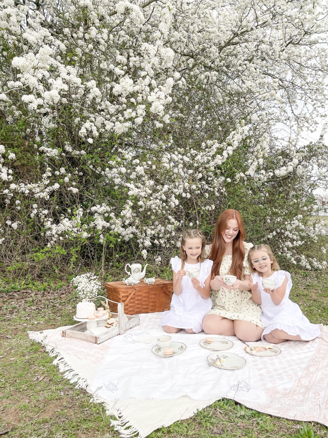 Kids dressing in white eyelet dressed for a tea party