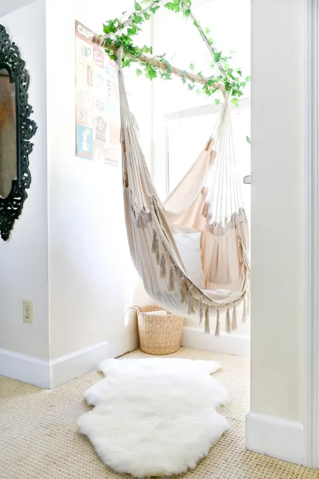 Adding a rug under a hammock swing in a cottagecore reading nook