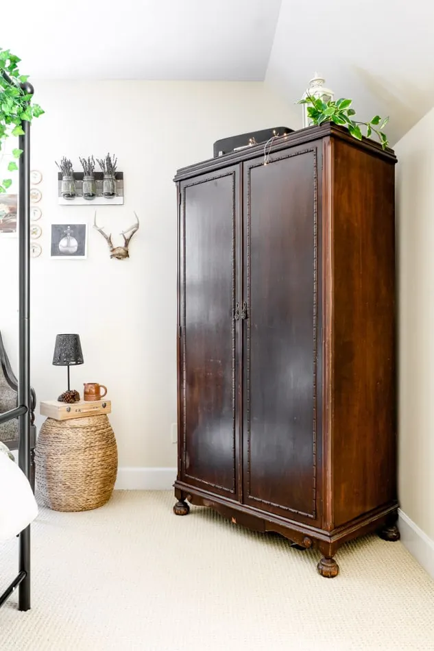 Antique armoire in a cottage style bedroom