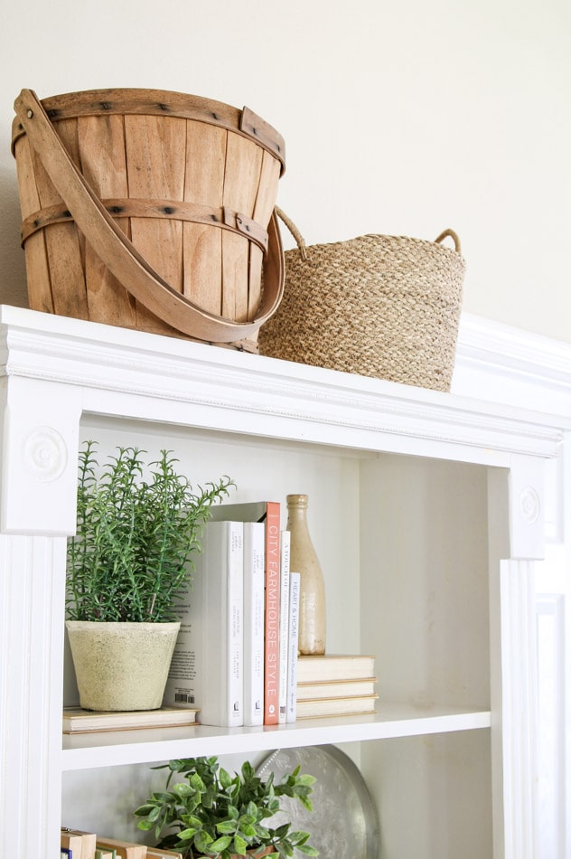 Decorating with baskets over a bookcase