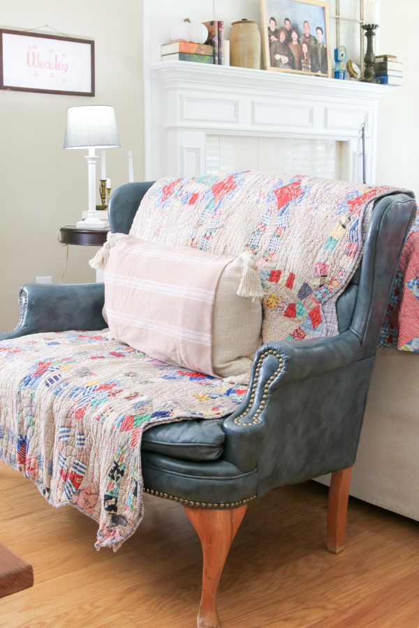 Small sofa draped with an old quilt