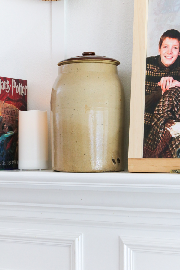 Old crock on mantel filled with flue powder as a decoration for a Harry Potter movie night