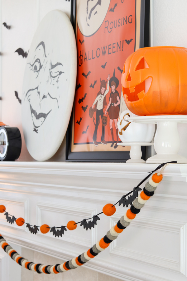 Decorating with ribbon on a Halloween fireplace mantel garland