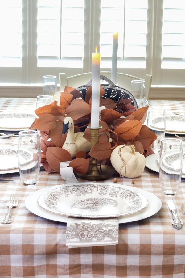 Decorating with ribbon on a Thanksgiving centerpiece