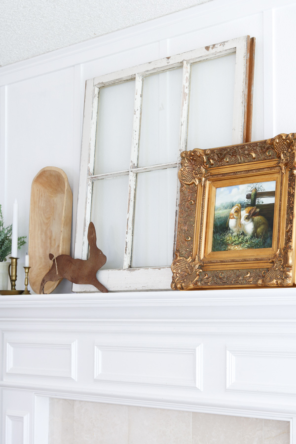 Rustic rabbit on a fireplace mantel and bunny art.  Decorating with rabbit ideas