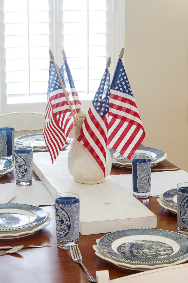 4th of July table decoration ideas centerpiece with ironstone pitcher filled with stick flags
