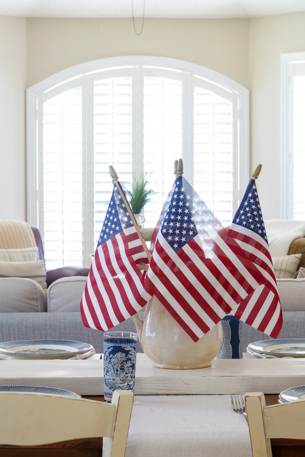 4th of July table decoration ideas centerpiece with ironstone pitcher filled with stick flags