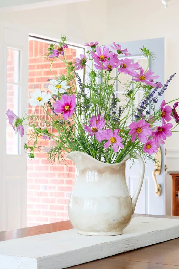 Fresh lavender flowers and cosmos in a ironstone pitcher as a centerpiece