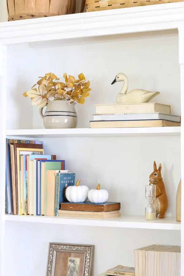 White pumpkins on a bookcase as a fall decoration