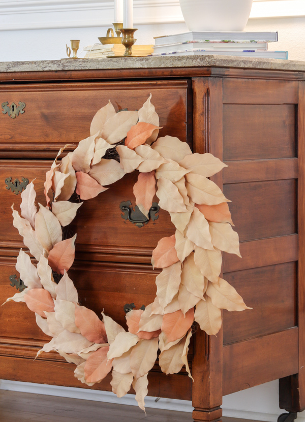 Wreath in neutral warm autumn colors as a decoration the front of a piece of furniture