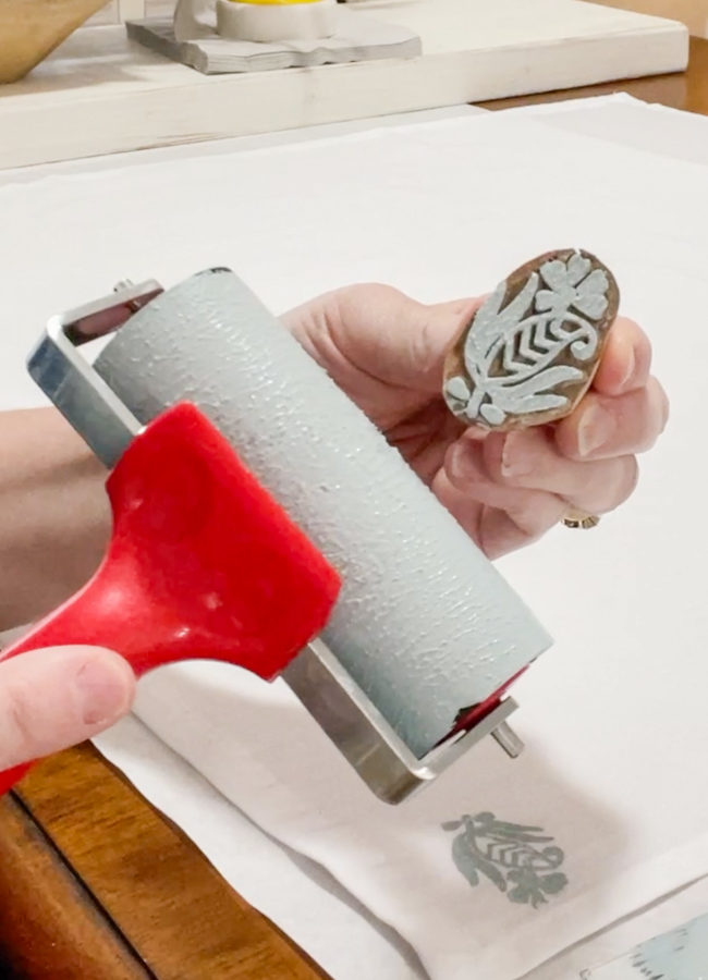 Using a brayer to apply chalk paint to wood block stamps