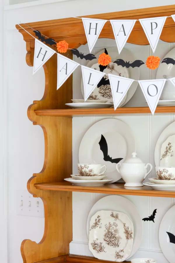 Paper DiY Halloween printables: black bat and pom pom garland diy and Happy Halloween pennant banner printable plus black bat silhouettes on dishes
