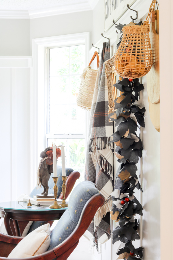 DIY Halloween paper leaf garland with berries hanging on wall in kitchen