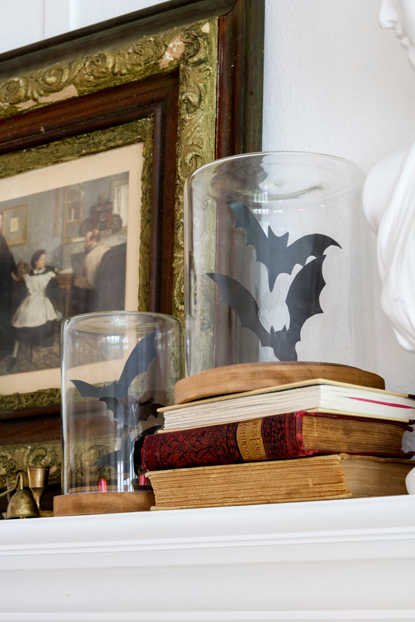 Printable bats in a cloche on fireplace mantel