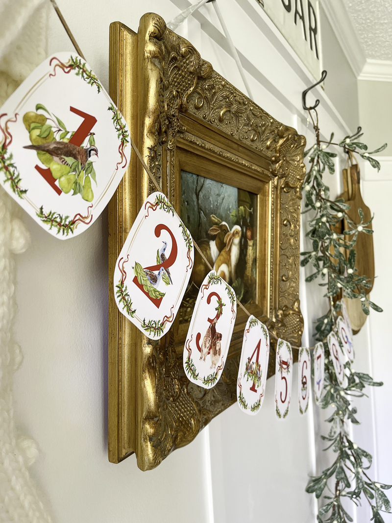 12 Days of Christmas garland printable decoration hanging on a wall for the holidays