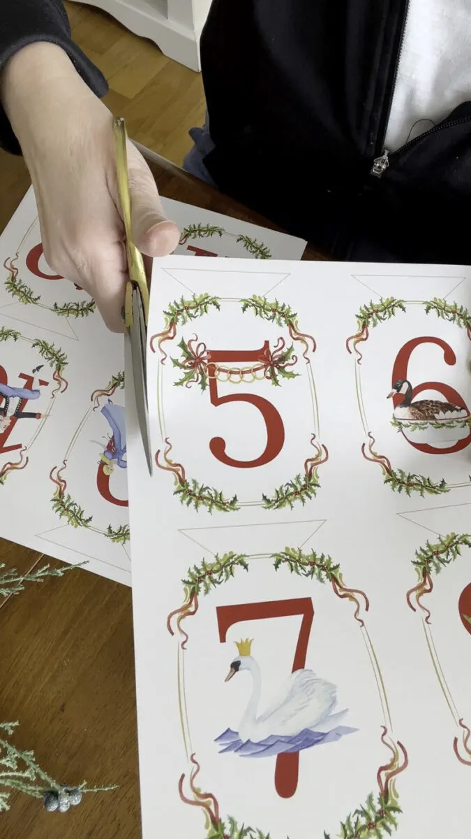 Cutting out each number from this 12 Days of Christmas garland printable