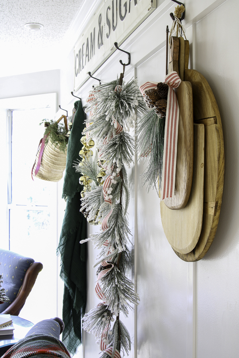 Winter wonderland Christmas decorations.  Vintage brad board, garlands, blankets and basket with cedar cuttings