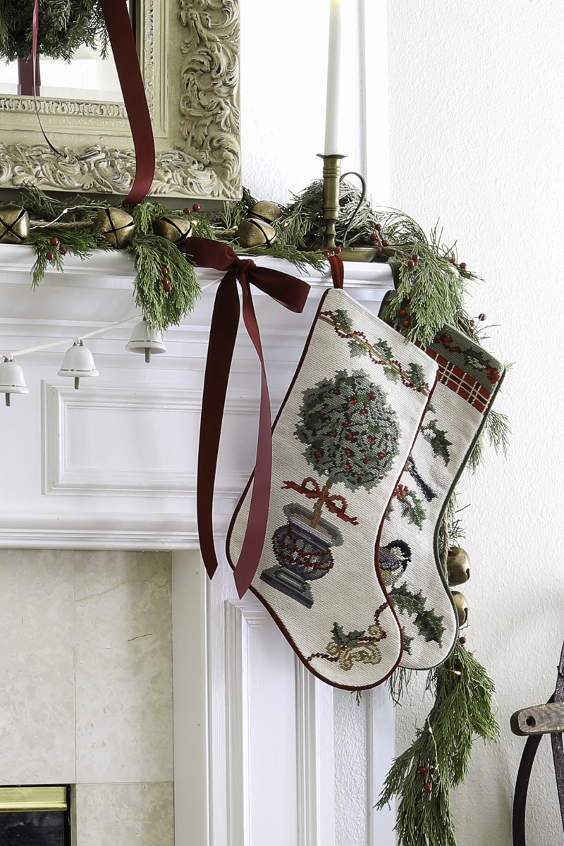 Decorating with ribbon and bows on a fireplace mantel for Christmas